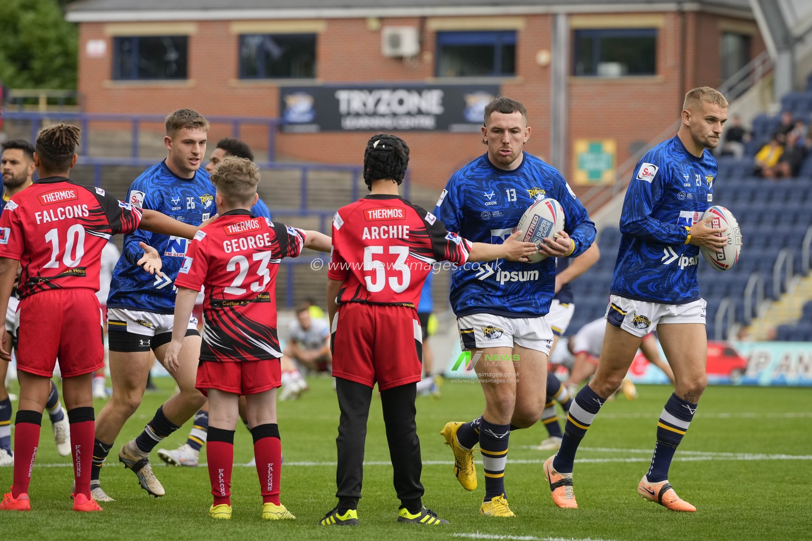 Leeds Rhinos players are greeted by young fans as the warm up before the Betfred Super League Round 21 match Leeds Rhinos vs Leigh Leopards at Headingley Stadium, Leeds, United Kingdom, 6th August 2023

(Photo by Steve Flynn/News Images)