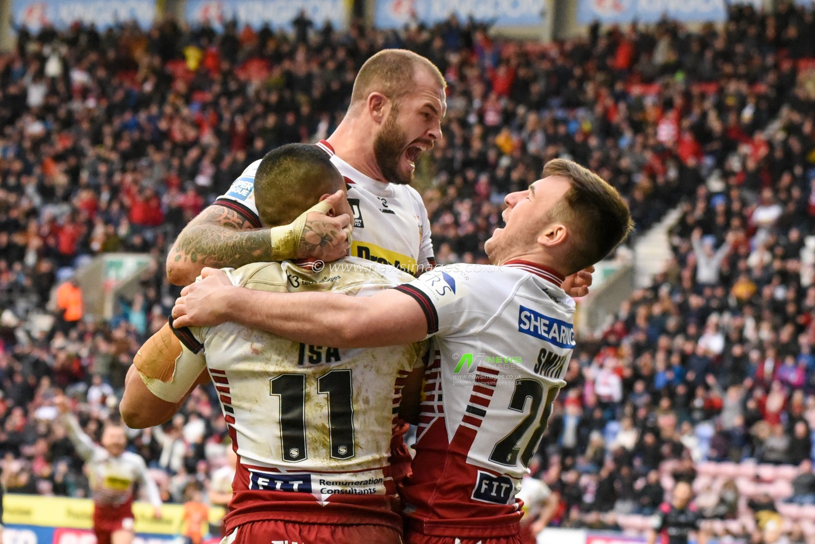 23rd February 2020, DW Stadium, Wigan, England; Betfred Super League, Wigan Warriors v Hull FC : Willie Isa (11) of Wigan Warriors celebrates with Zak Hardaker (1) and Harry Smith (28)