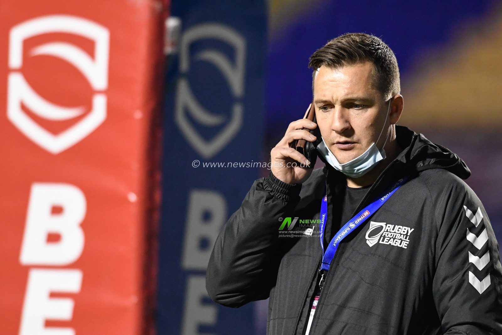 Referee Ben Thaler takes a phone call before the players arrive