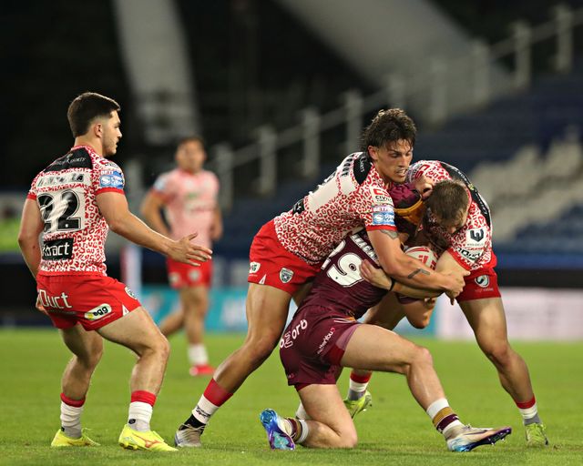George Flanagan of Huddersfield Giants is tackled by Owen Trout of Leigh Leopards and Matt Davis of Leigh Leopards during the Betfred Super League Round 13 match Huddersfield Giants vs Leigh Leopards at John Smith's Stadium, Huddersfield, United Kingdom, 29th May 2025

(Photo by Sam Eaden/News Images)