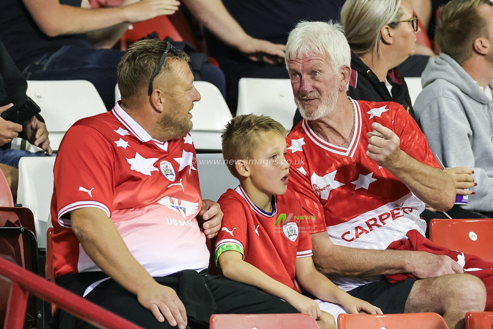 Barnsley fans in the East Stand with the new and old replica shirts, the new one designed by KidSuper for Puma during the EFL Trophy match Barnsley vs Grimsby Town at Oakwell, Barnsley, United Kingdom, 5th September 2023

(Photo by Mark Cosgrove/News Images)