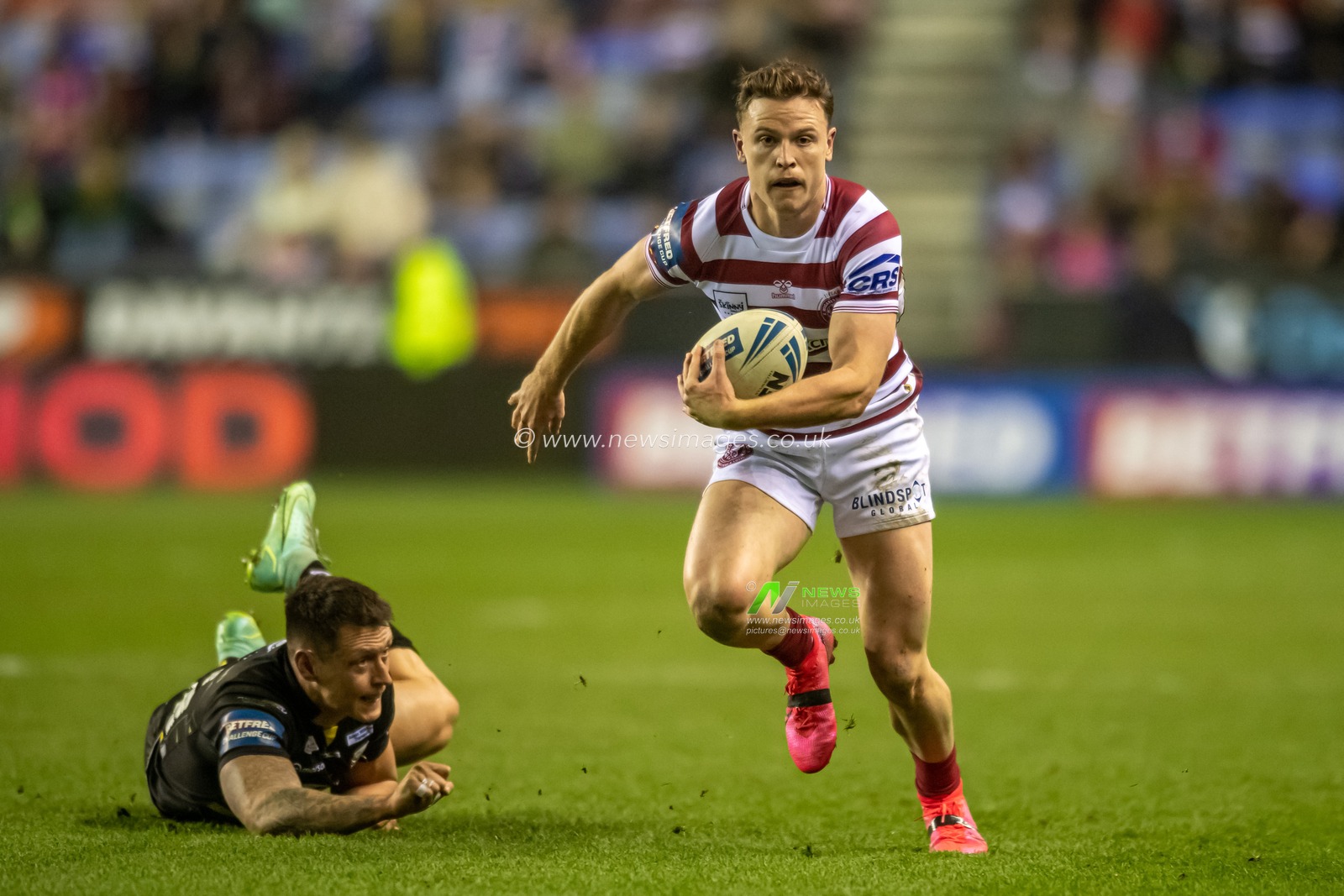 Jai Field #23 of Wigan Warriors runs forward with the ball