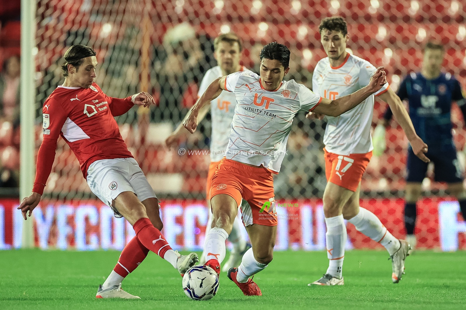 Kenny Dougall #12 of Blackpool wins the ball from Callum Brittain #7 of Barnsley