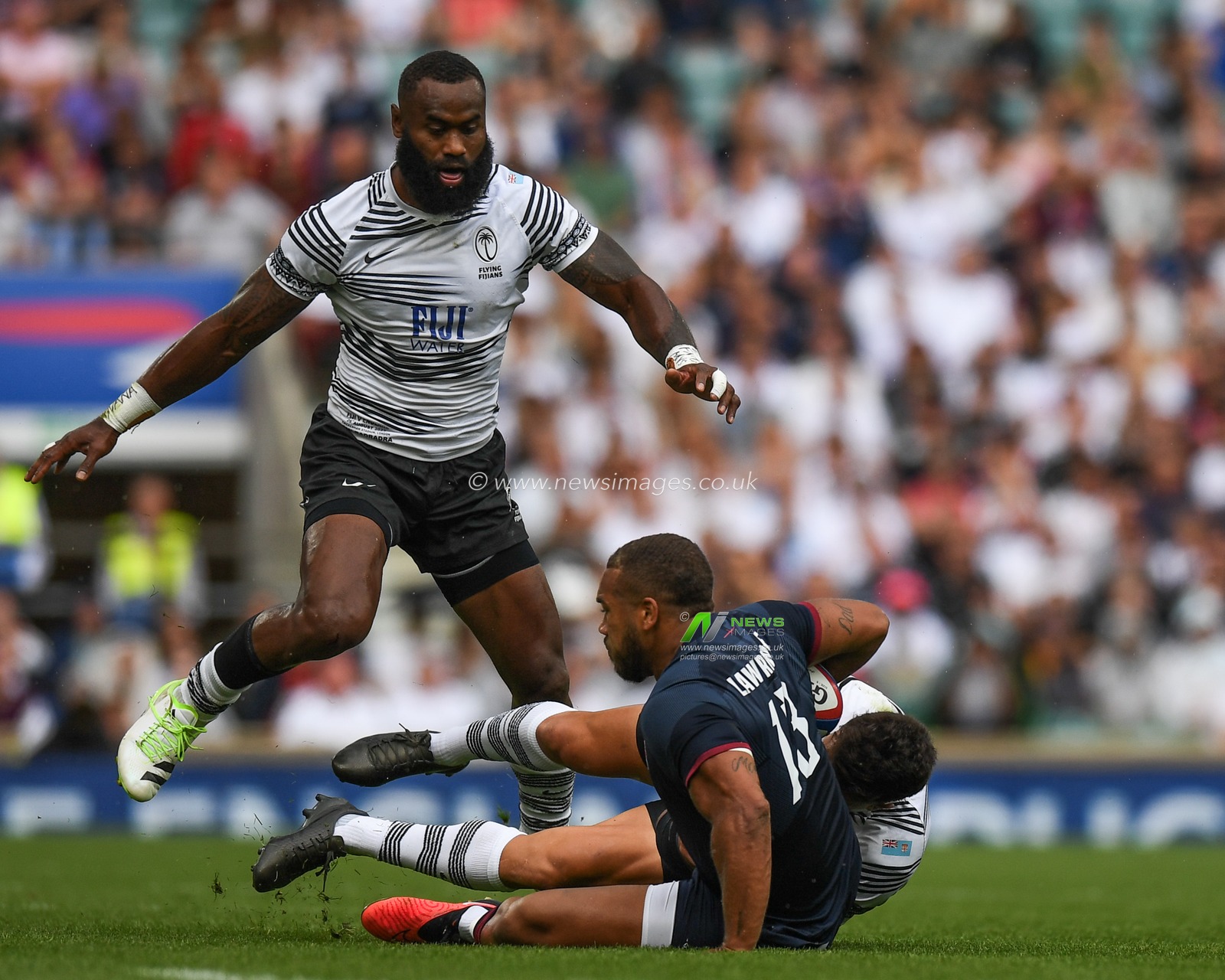 Ollie Lawrence of England tackled by Caleb Muntz of Fiji and Semi Radradra of Fiji during the 2023 Summer Series match England vs Fiji at Twickenham Stadium, Twickenham, United Kingdom, 26th August 2023

(Photo by Mike Jones/News Images)