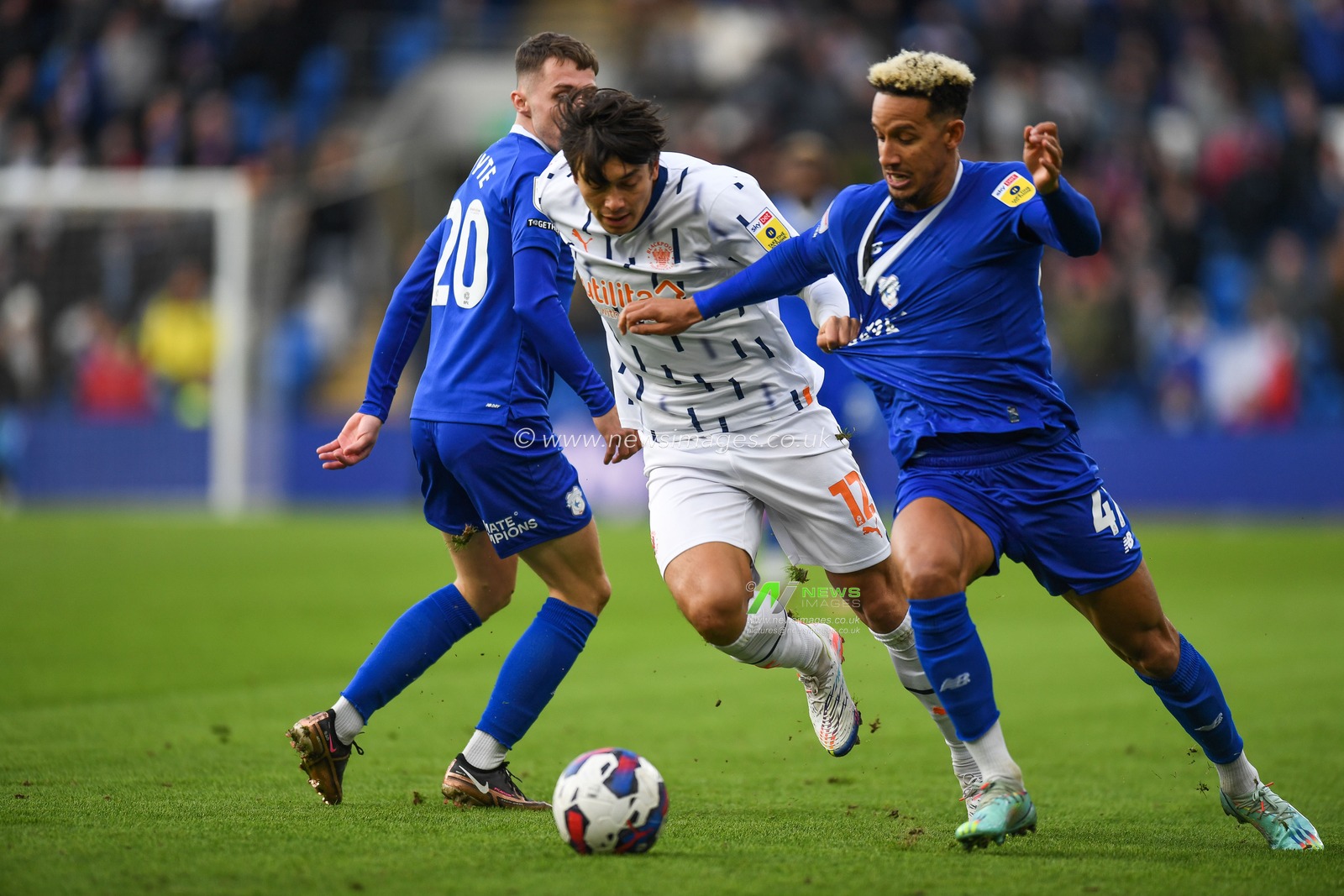 Kenny Dougall #12 of Blackpool Under pressure from Gavin Whyte #20 of Cardiff City  and Callum Robinson #47 of Cardiff City during the Sky Bet Championship match Cardiff City vs Blackpool at Cardiff City Stadium, Cardiff, United Kingdom, 17th December 2022

(Photo by Mike Jones/News Images)