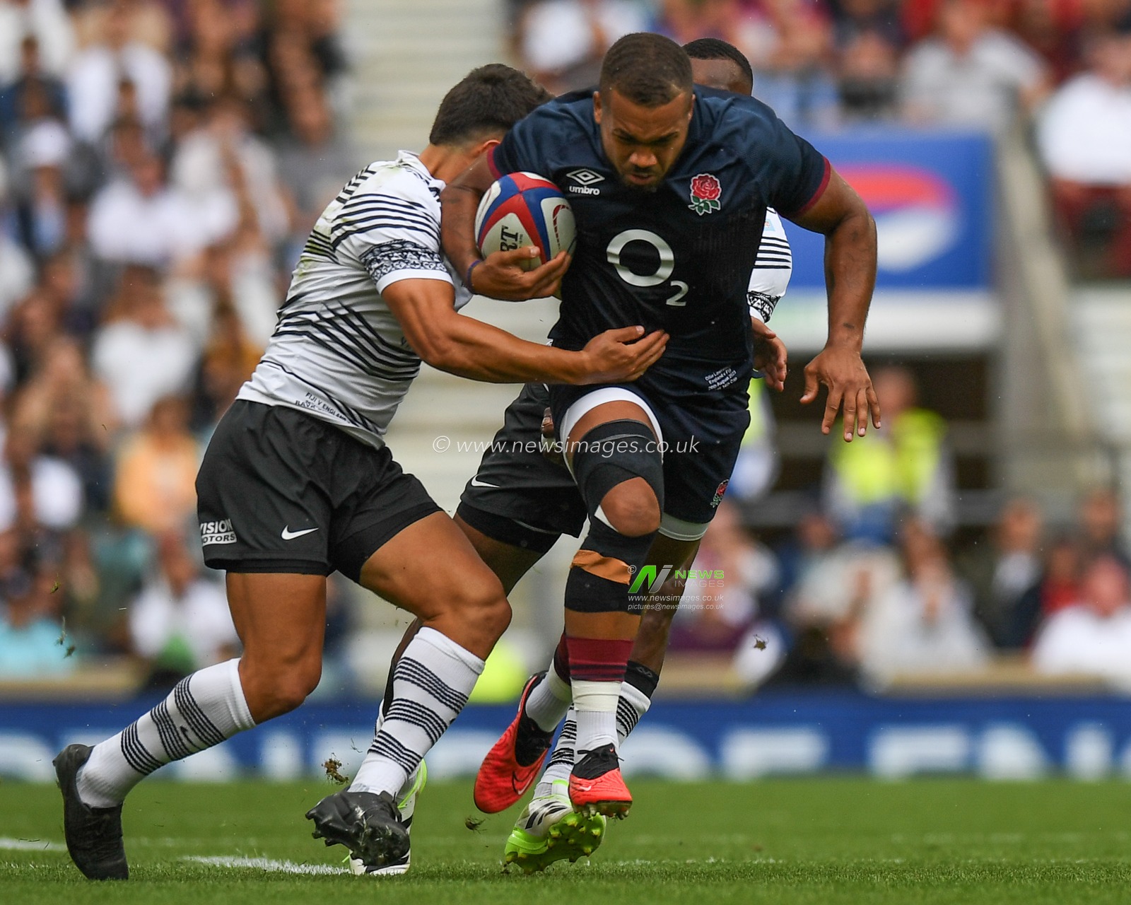Ollie Lawrence of England tackled by Caleb Muntz of Fiji and Semi Radradra of Fiji during the 2023 Summer Series match England vs Fiji at Twickenham Stadium, Twickenham, United Kingdom, 26th August 2023

(Photo by Mike Jones/News Images)