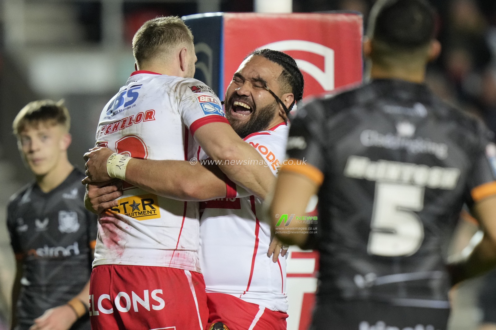 Konrad Hurrell of St. Helens celebrates with try scorer Joe Batchelor of St. Helens during the Betfred Super League  Round 8 match St Helens vs Hull FC at Totally Wicked Stadium, St Helens, United Kingdom, 19th April 2024

(Photo by Steve Flynn/News Images)
