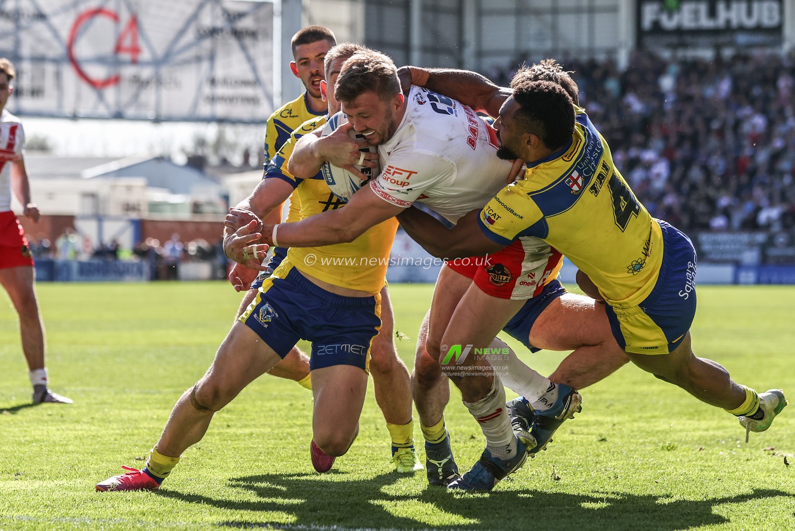 Matt Dufty of Warrington Wolves, Adam Holroyd of Warrington Wolves and Rodrick Tai of Warrington Wolves tackle Joe Batchelor of St. Helens to prevent a try during the Betfred Challenge Cup Quarter Final match Warrington Wolves vs St Helens at Halliwell Jones Stadium, Warrington, United Kingdom, 6th April 2025

(Photo by Alfie Cosgrove/News Images)
