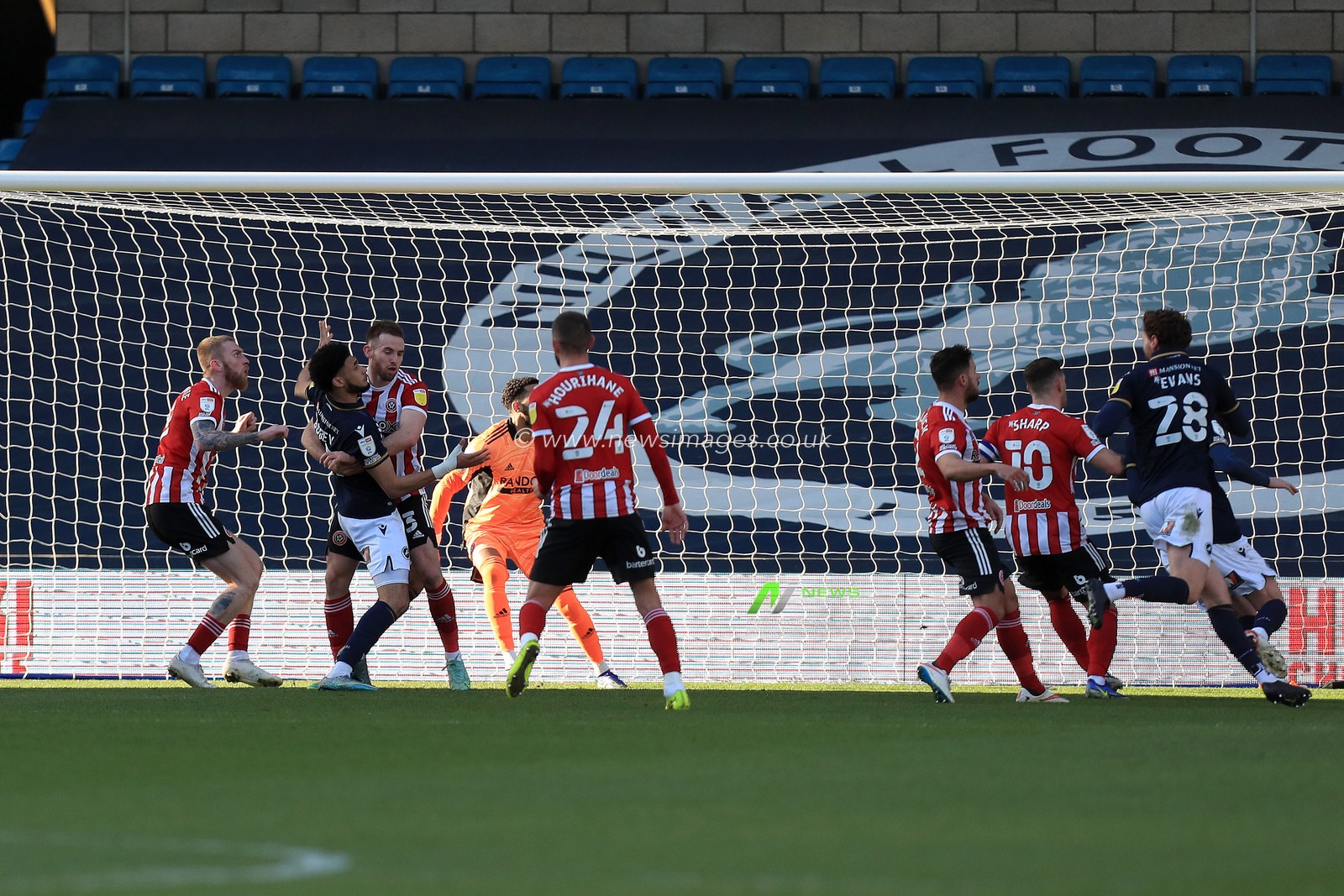 Rhys Norrington-Davies #33 of Sheffield United tussles with Tyler Burey #32 of Millwall.