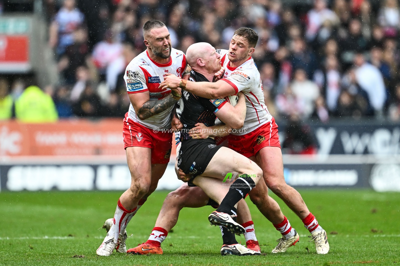 Liam Farrell of Wigan Warriors is tackled by Curtis Sironen of St. Helens and Morgan Knowles of St. Helens during the Betfred Super League Round 6 match St Helens vs Wigan Warriors at Totally Wicked Stadium, St Helens, United Kingdom, 29th March 2024

(Photo by Craig Thomas/News Images)