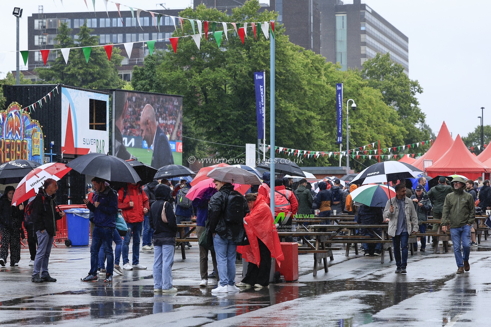Cricket fans watching the womenâ€™s World Cup on the big screen in the rain ahead of the LV= Insurance Ashes Test Series Fourth Test Day Four match England vs Australia at Old Trafford, Manchester, United Kingdom, 22nd July 2023

(Photo by Conor Molloy/News Images)