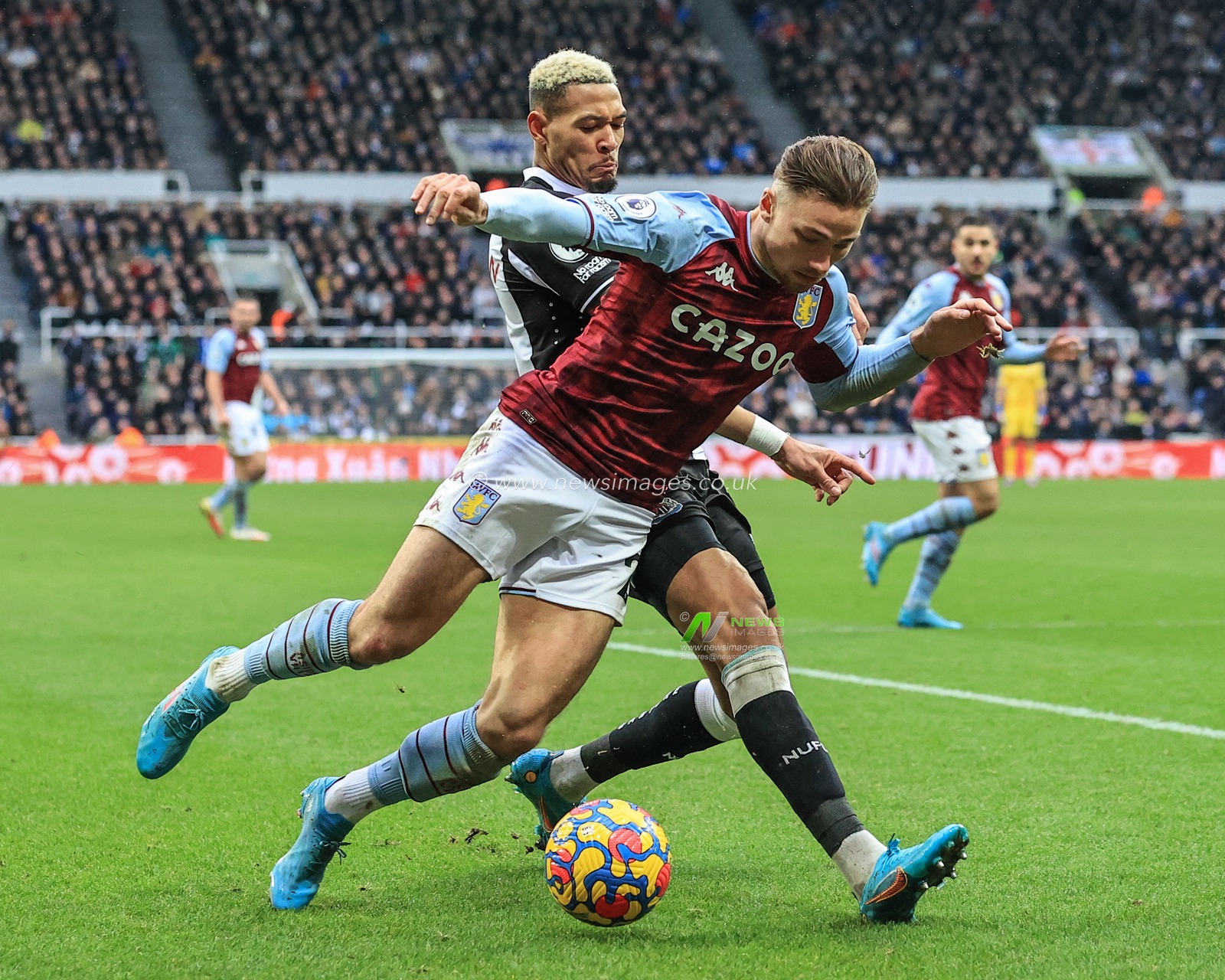 Matty Cash #2 of Aston Villa is tackled by Joelinton #7 of Newcastle United