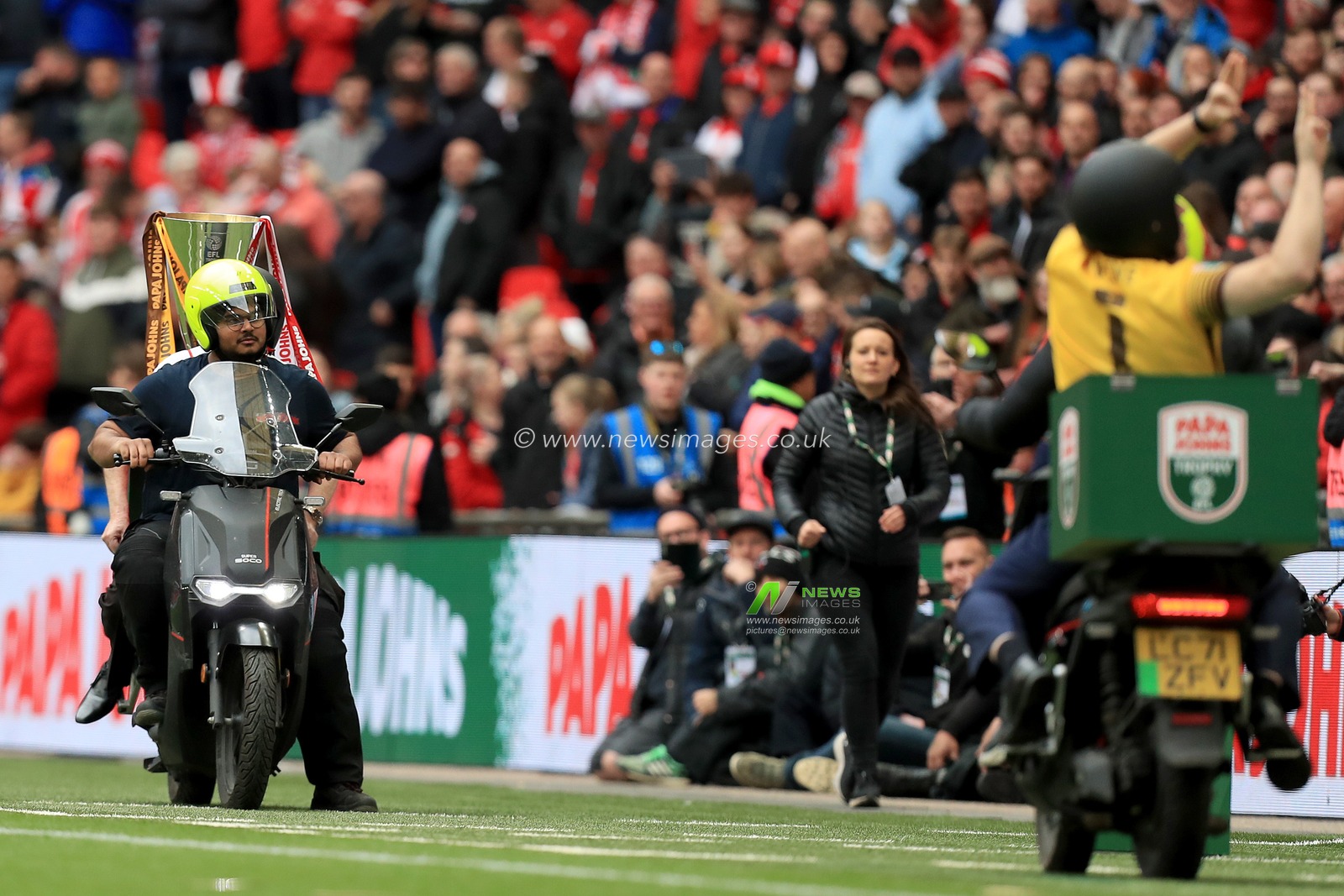Paul Chuckle and Tim Vine deliver the trophy and match ball prior to kick off.