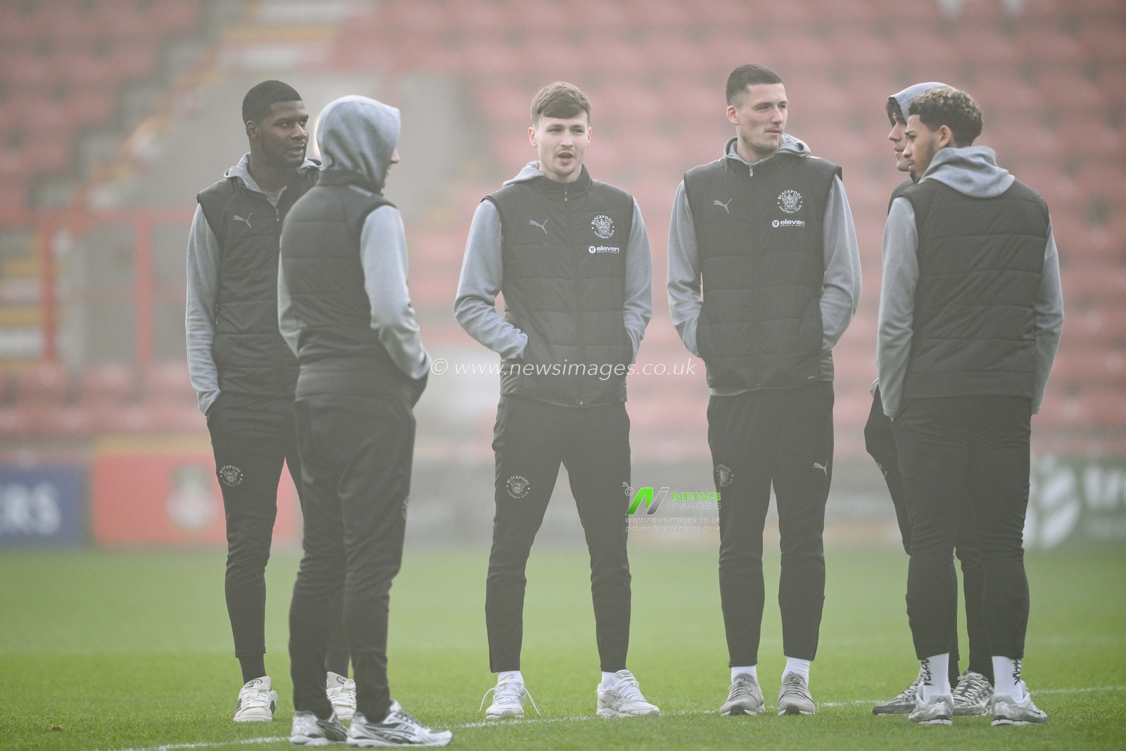 Blackpool  players stand on the foggy pitch as he arrives ahead of the Sky Bet League 1 match Wrexham vs Blackpool at SToK Cae Ras, Wrexham, United Kingdom, 26th December 2024

(Photo by Craig Thomas/News Images)