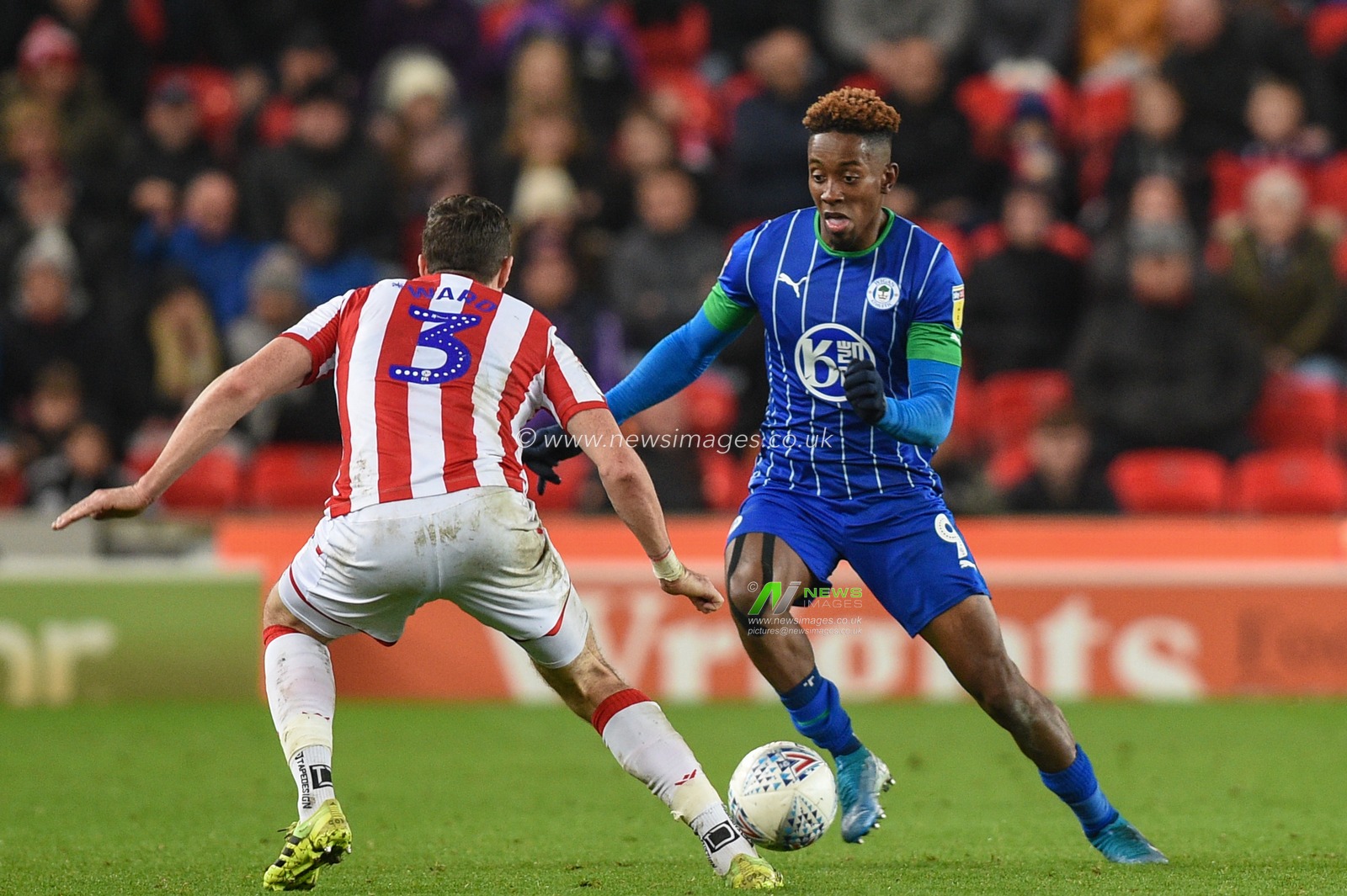 23rd November 2019, Bet365 Stadium, Stoke-on-Trent, England; Sky Bet Championship, Stoke City v Wigan Athletic : Jamal Lowe (9) of Wigan Athletic ahead of Stephen Ward (3) of Stoke City 

Credit: Richard Long/News Images