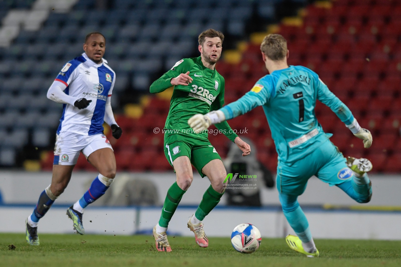 Thomas Kaminski #1 of Blackburn Rovers clears the ball under pressure from Tom Barkhuizen #29 of Preston North End