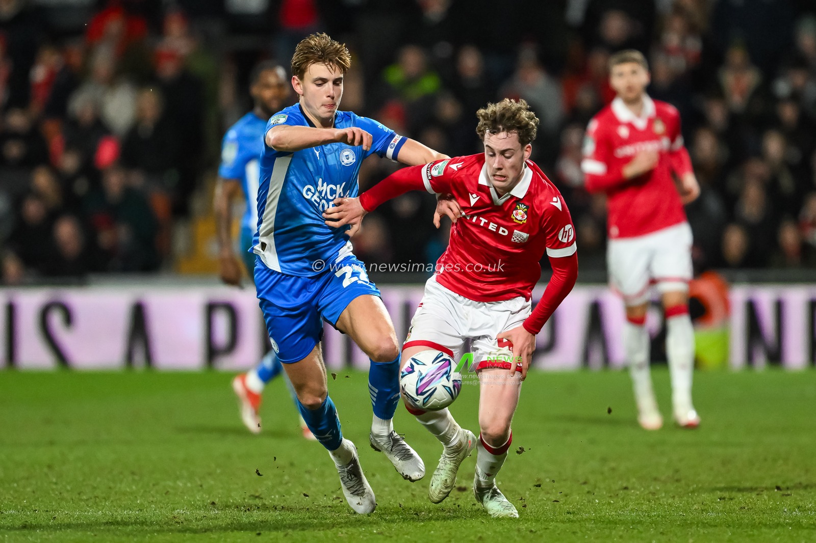 Harry Ashfield of Wrexham and Hector Kyprianou of Peterborough United battle for the ball during the The Vertu Trophy Semi-finals Wrexham vs Peterborough United at SToK Cae Ras, Wrexham, United Kingdom, 26th February 2025

(Photo by Craig Thomas/News Images)