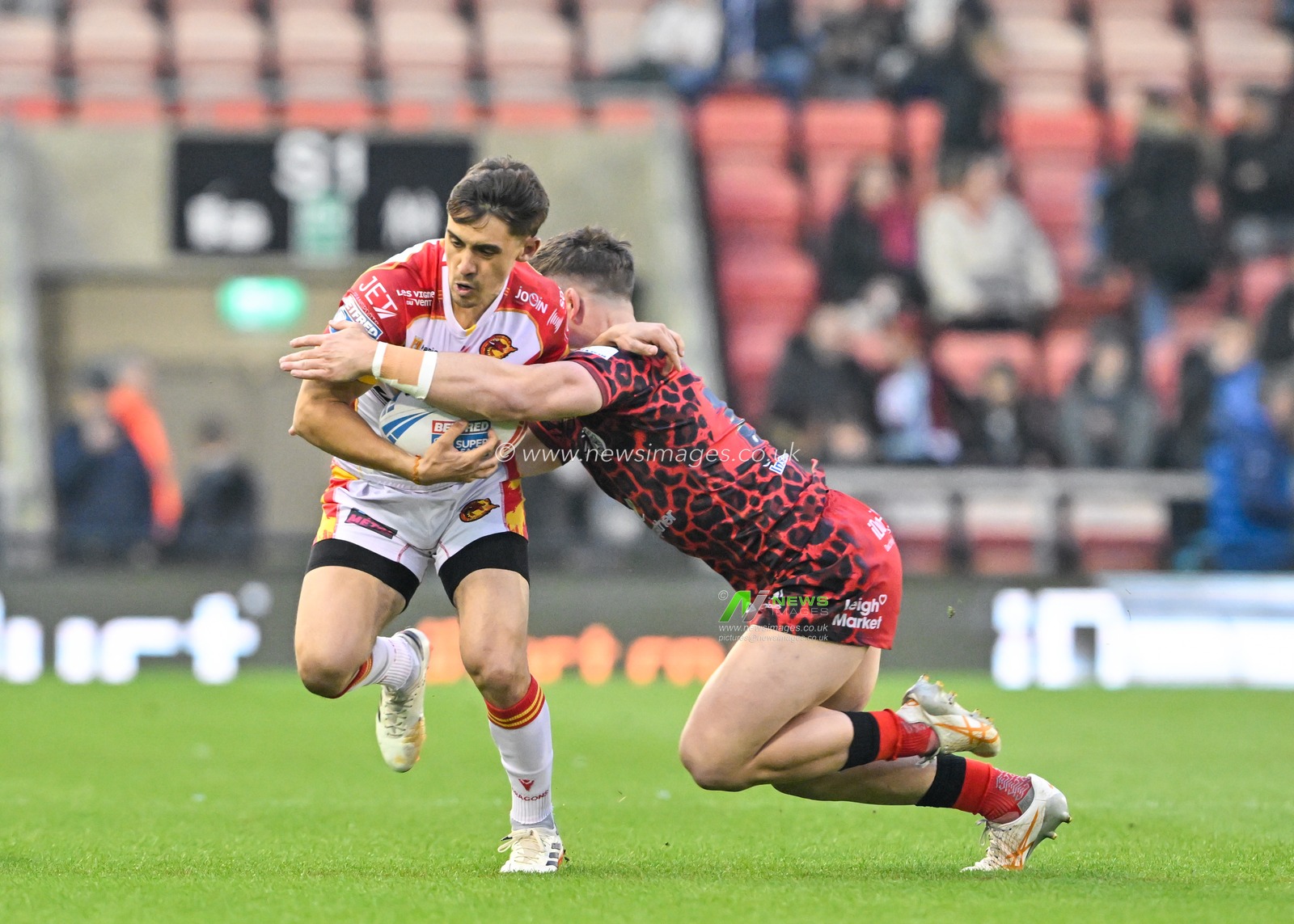 Arthur Mourgue of Catalan Dragons is tackled by Kai Oâ€™Donnell of Leigh Leopards, during the Betfred Super League Round 9 match Leigh Leopards vs Catalans Dragons at Leigh Sports Village, Leigh, United Kingdom, 26th April 2024

(Photo by Cody Froggatt/News Images)