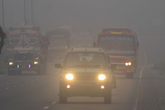 Commuters ride along National Highway NH12 amid dense fog on a cold winter morning in Howrah,West Bengal,Pictures by Debajyoti Chakraborty.(Photo: Debajyoti Chakraborty/News Images)