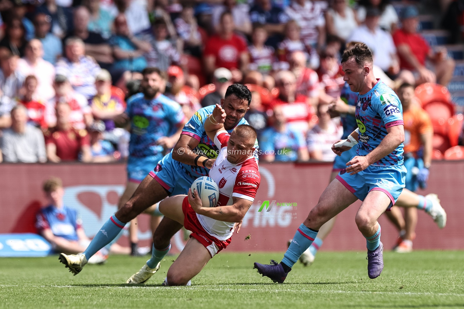 Mikey Lewis of Hull KR is tackled by Bevan French of Wigan Warriors during the Betfred Challenge Cup Semi-Final Hull KR v Wigan Warriors at Eco-Power Stadium, Doncaster, United Kingdom, 18th May 2024

(Photo by Mark Cosgrove/News Images)