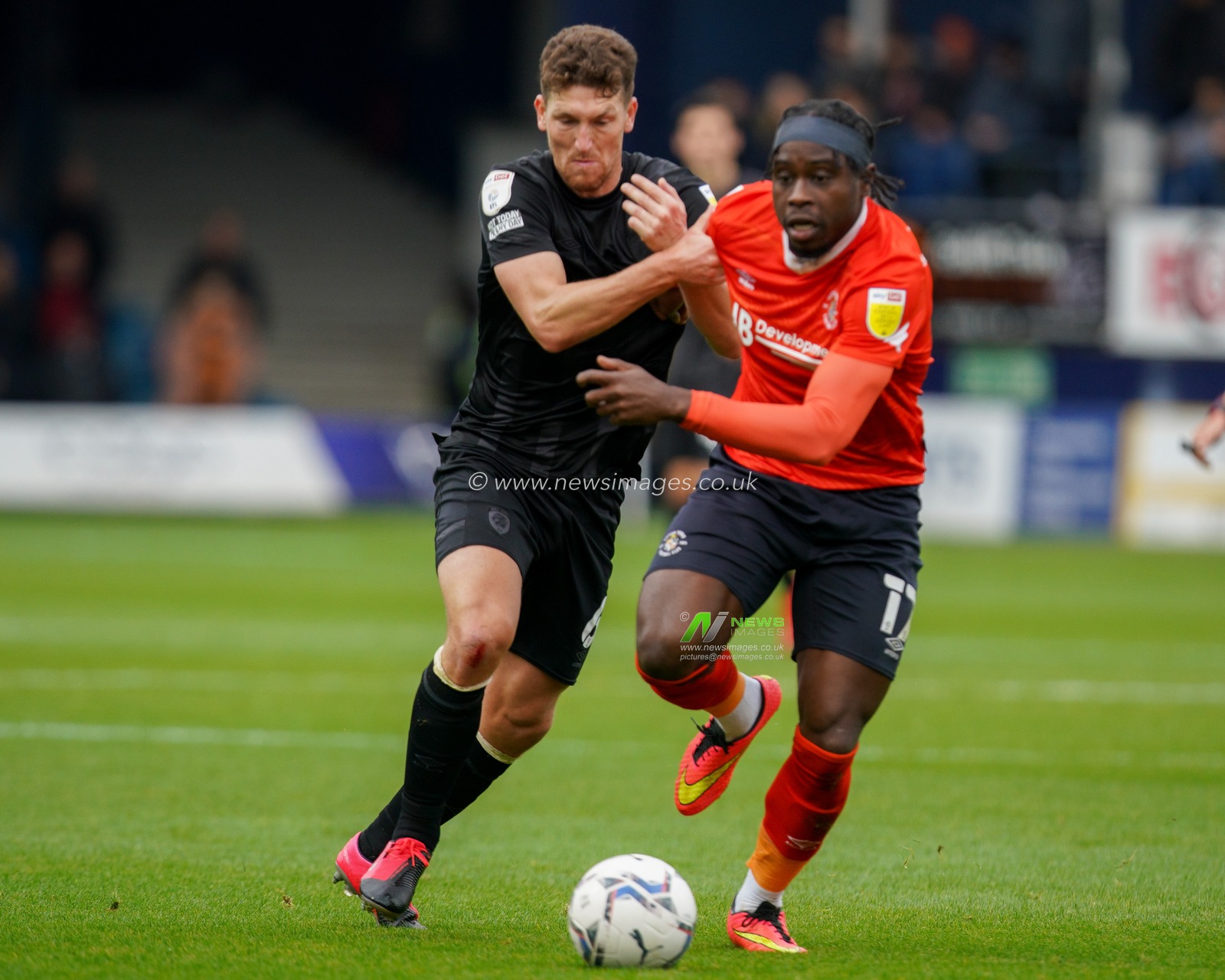 Richard Smallwood #6 of Hull City battles with Pelly Ruddock Mpanzu #17 of Luton Town