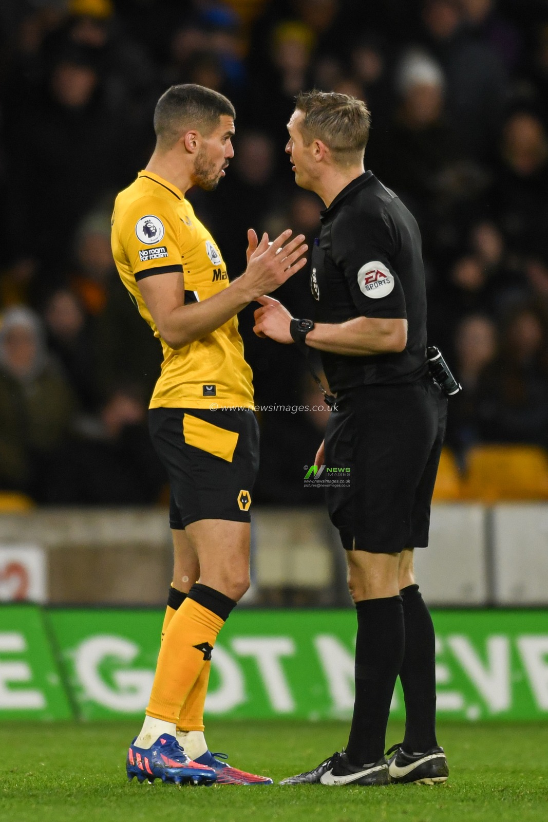 Conor Coady #16 of Wolverhampton Wanderers speaks to referee Craig Pawson