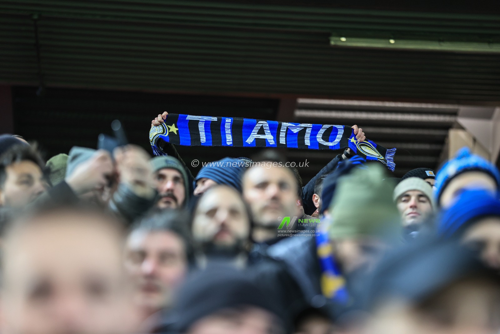 An Inter Milan fan holding his scarf up