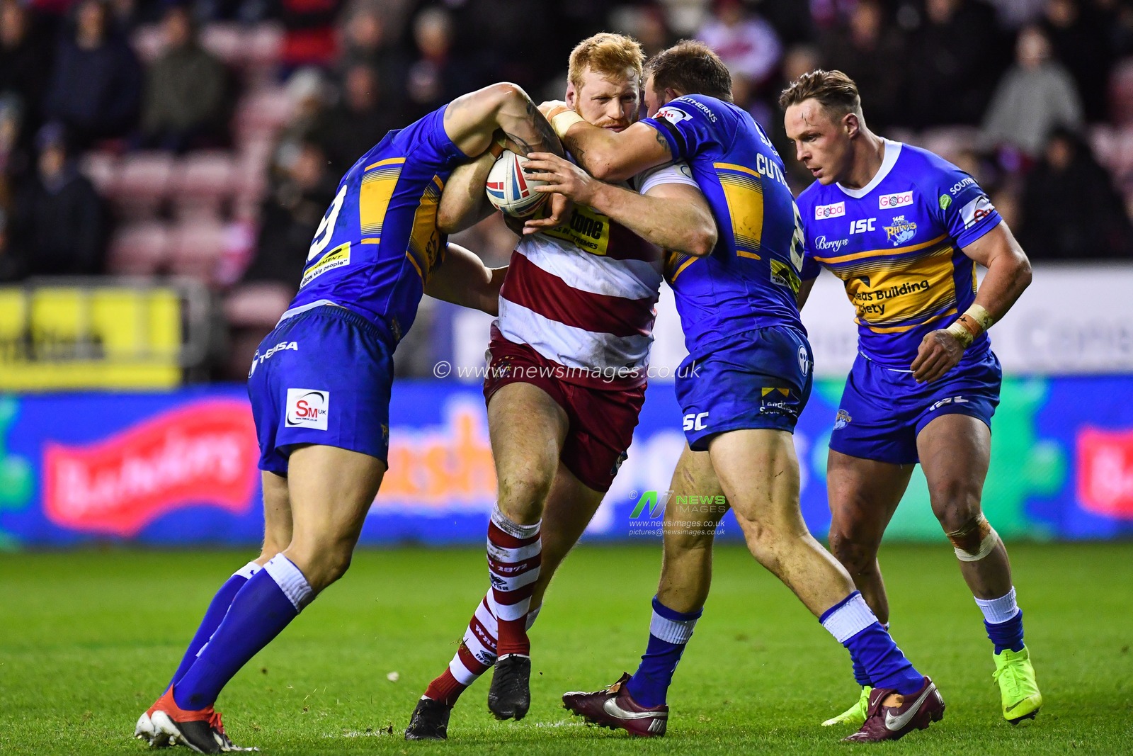 8th February  2019 , DW Stadium, Wigan, England;  Betfred Super League, Round 2, Wigan Warriors vs Leeds Rhinos ; Joe Bullock (22) of Wigan Warriors is tackled by Adam Cuthbertson (8) of Leeds Rhinos 

Credit: Craig Thomas/News Images