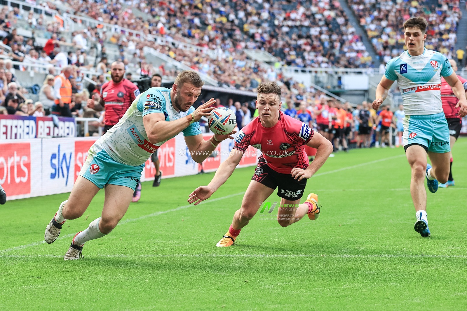 Joe Batchelor #12 of St Helens goes over for a try
