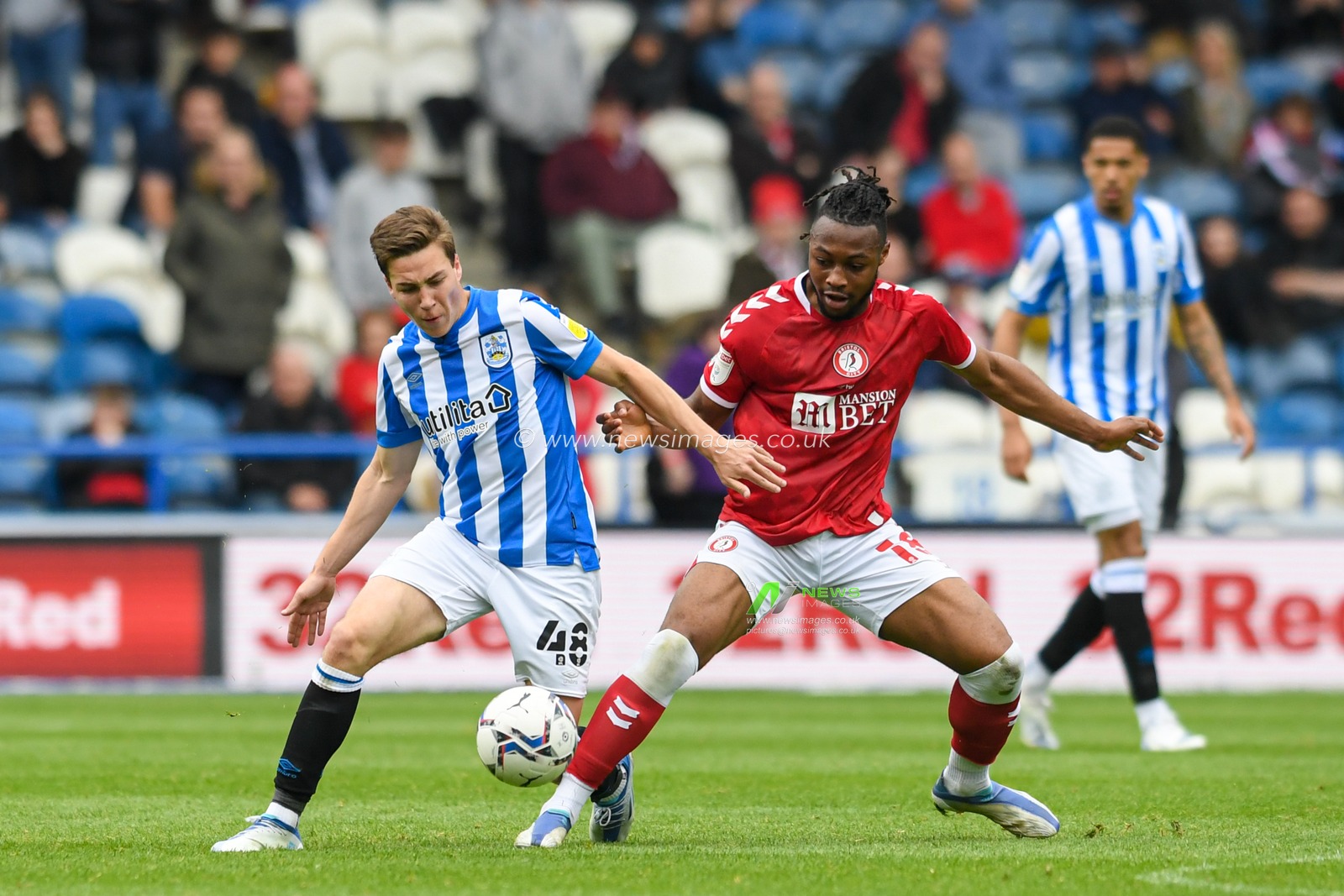 Carel Eiting #48 of Huddersfield Town competes with Antoine Semenyo #18 of Bristol City for the ball