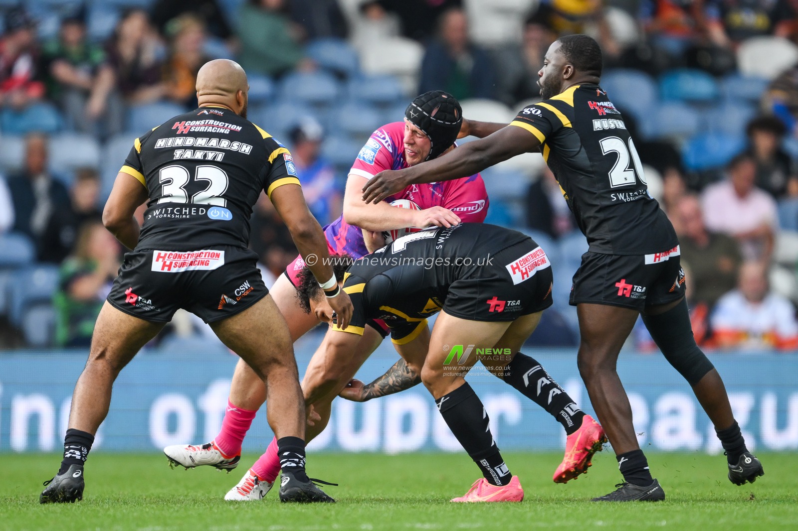 Chris Hill of Huddersfield Giants is tackled by Liam Horne of Castleford Tigers and Muizz Mustapha of Castleford Tigers during the Magic Weekend match Huddersfield Giants vs Castleford Tigers at Elland Road, Leeds, United Kingdom, 18th August 2024

(Photo by Craig Thomas/News Images)