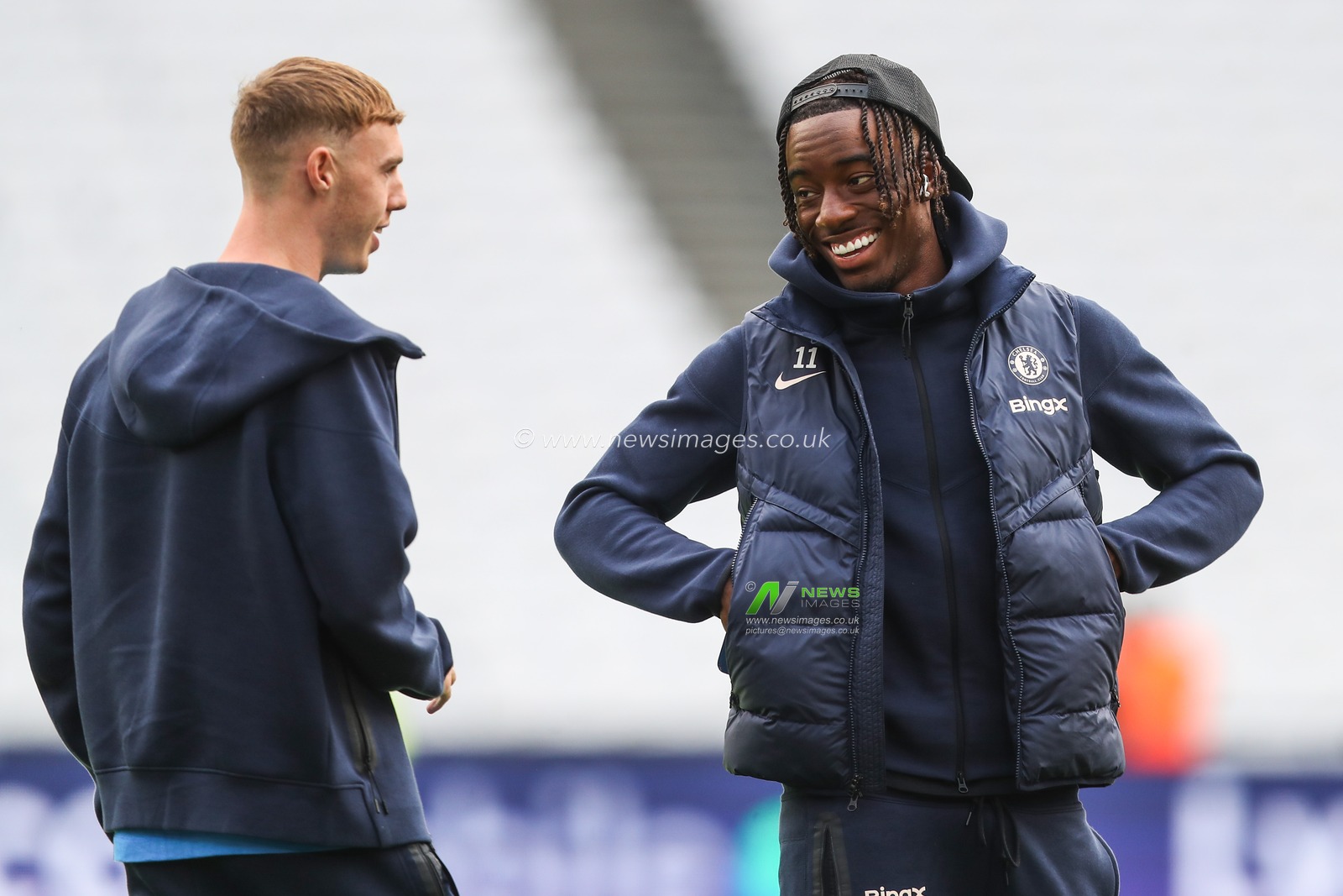 Cole Palmer of Chelsea and Noni Madueke of Chelsea share a joke as they arrive ahead of the Premier League match West Ham United vs Chelsea at London Stadium, London, United Kingdom, 21st September 2024

(Photo by Gareth Evans/News Images)