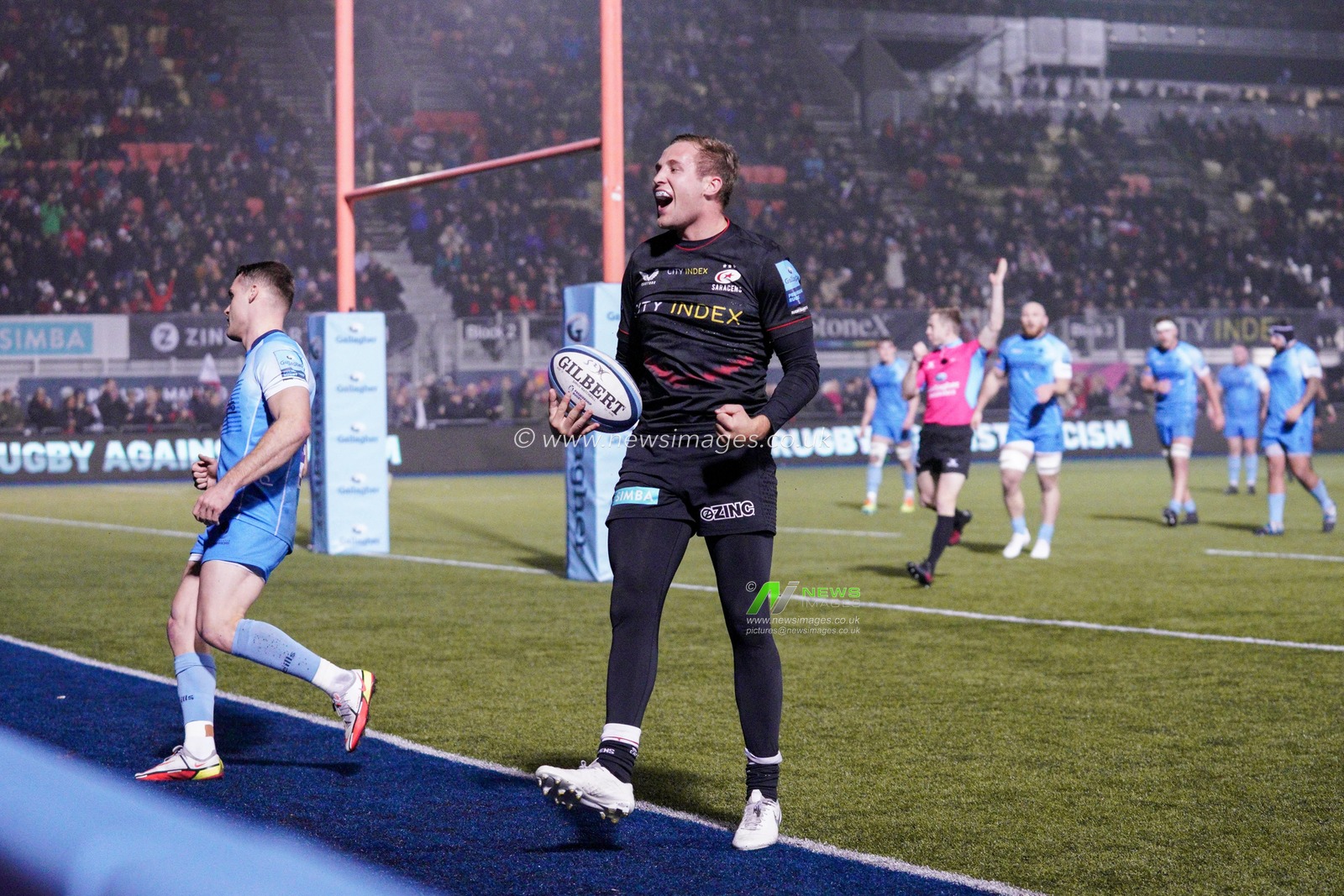 Max Malins #15 of Saracens scores a try and celebrates to the fans