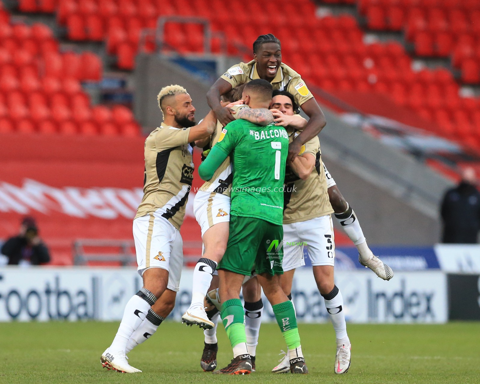 James Coppinger #26 of Doncaster Rovers runs back to Ellery Balcombe #1 of Doncaster Rovers to celebrate his goal to make it 3-3