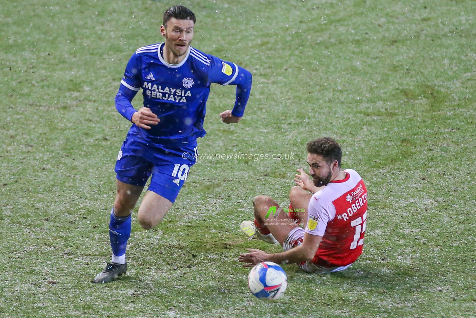 Kieffer Moore #10 of Cardiff City takes the ball past Clark Robertson #15 of Rotherham United