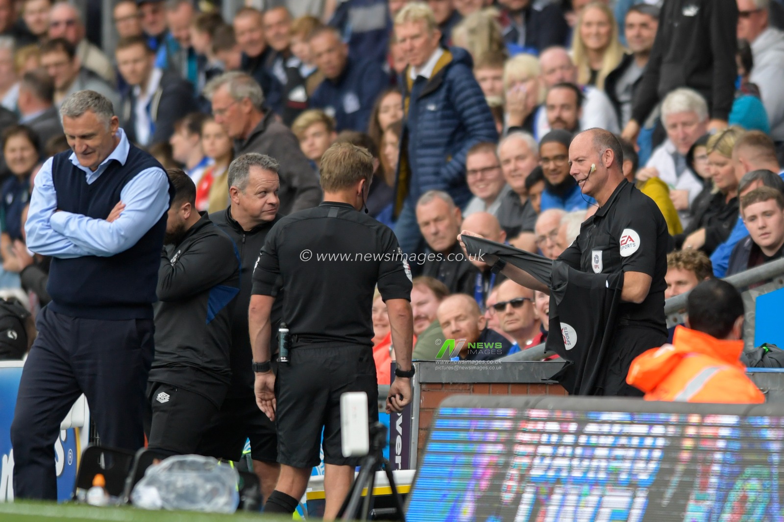 Fourth official Andy Haines prepares for refereeing duties after match referee Oliver Langford leaves the pitch due to an injury