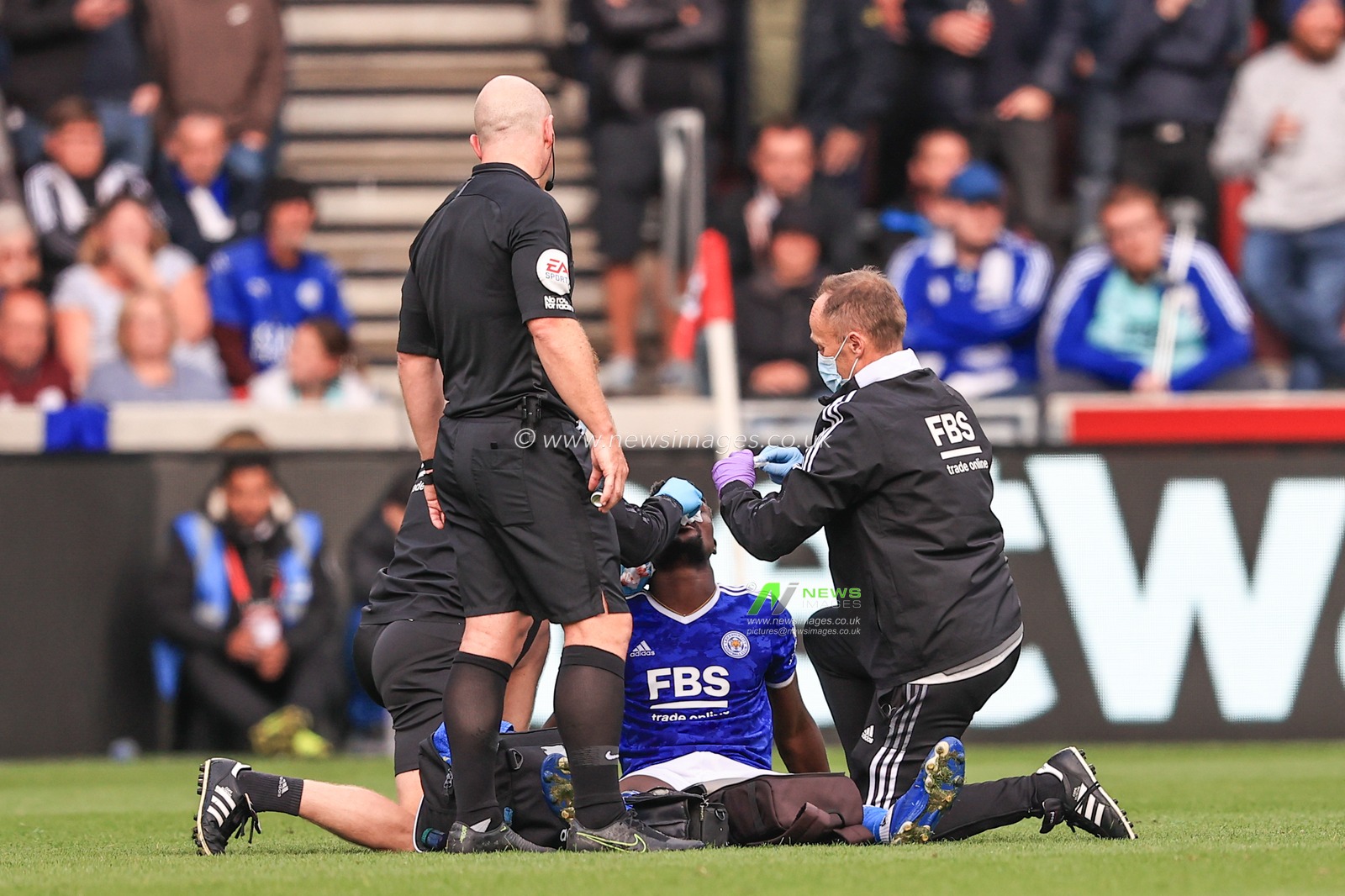 Daniel Amartey #18 of Leicester City receives treatment for a busted nose