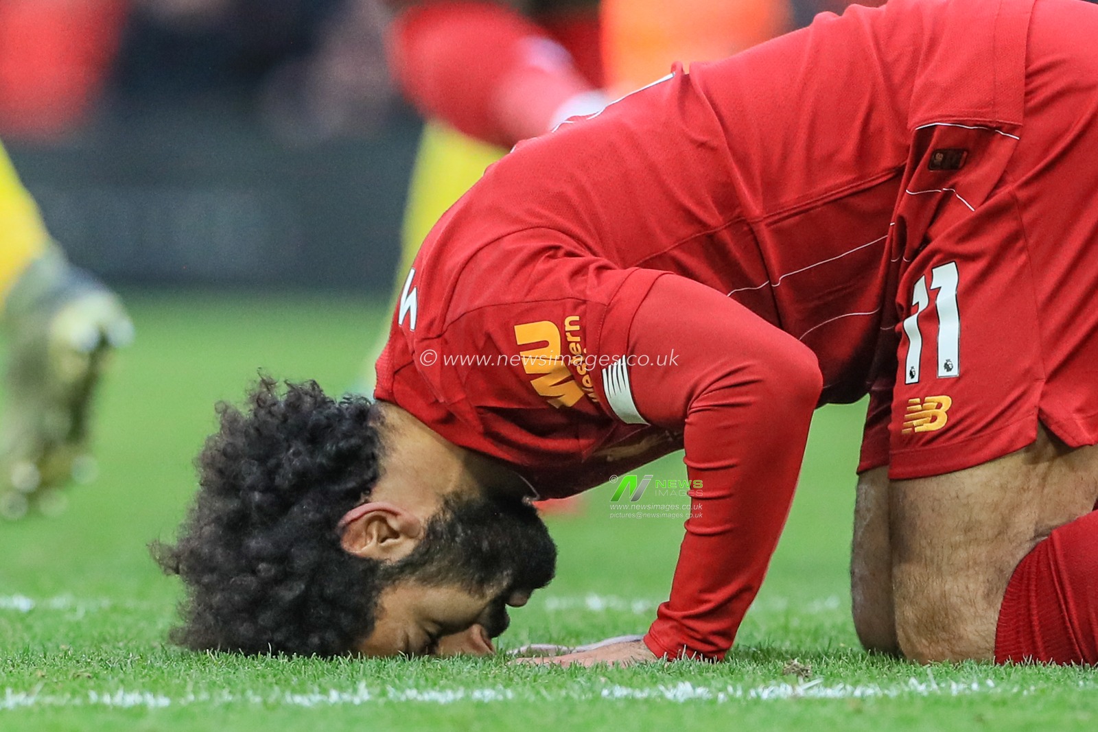 14th December 2019, Anfield, Liverpool, England; Premier League, Liverpool v Watford :  Mohamed Salah (11) of Liverpool celebrates his goal to make it 2-0 and kisses the ground 

Credit: Mark Cosgrove/News Images
