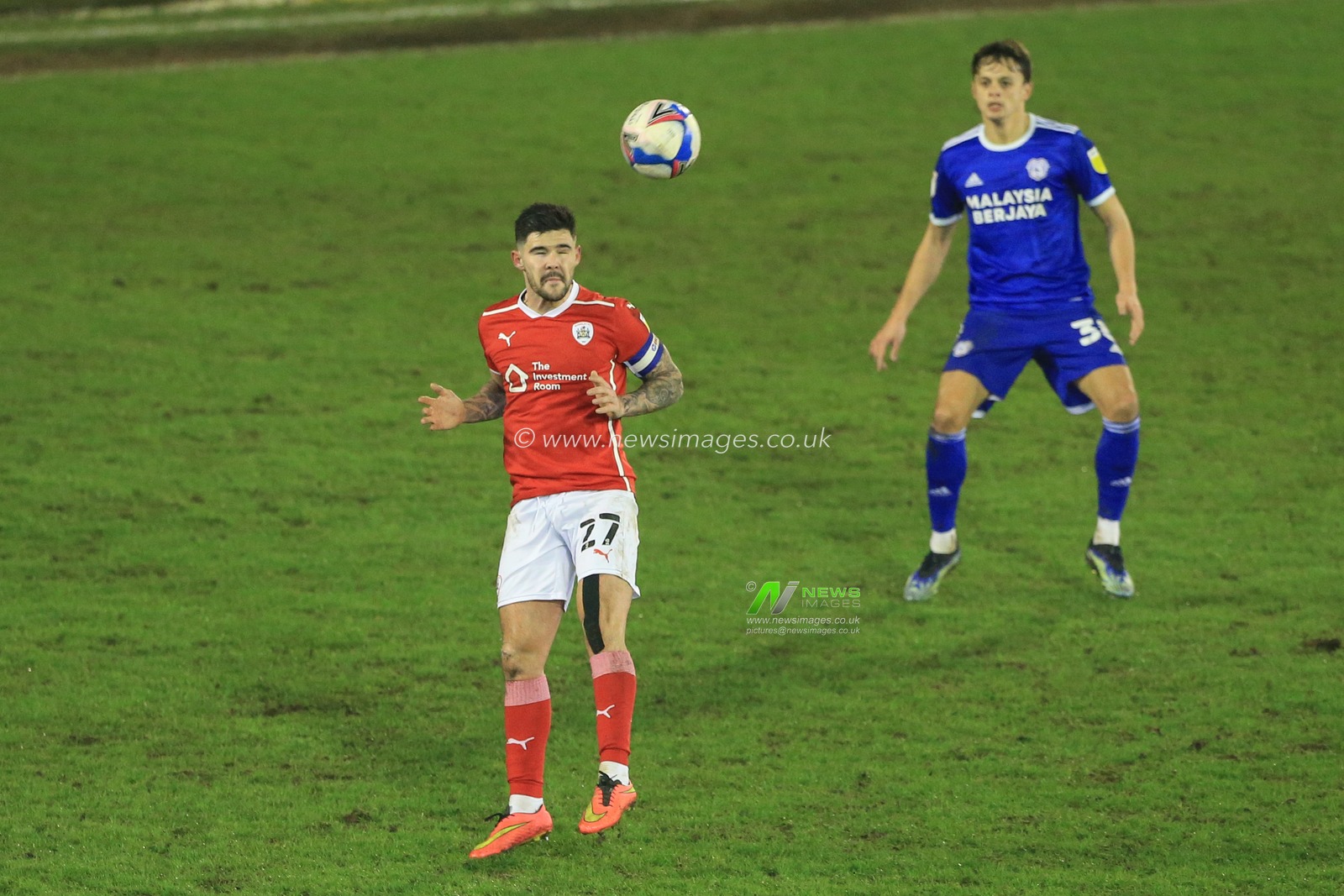 Alex Mowatt #27 of Barnsley heads the ball