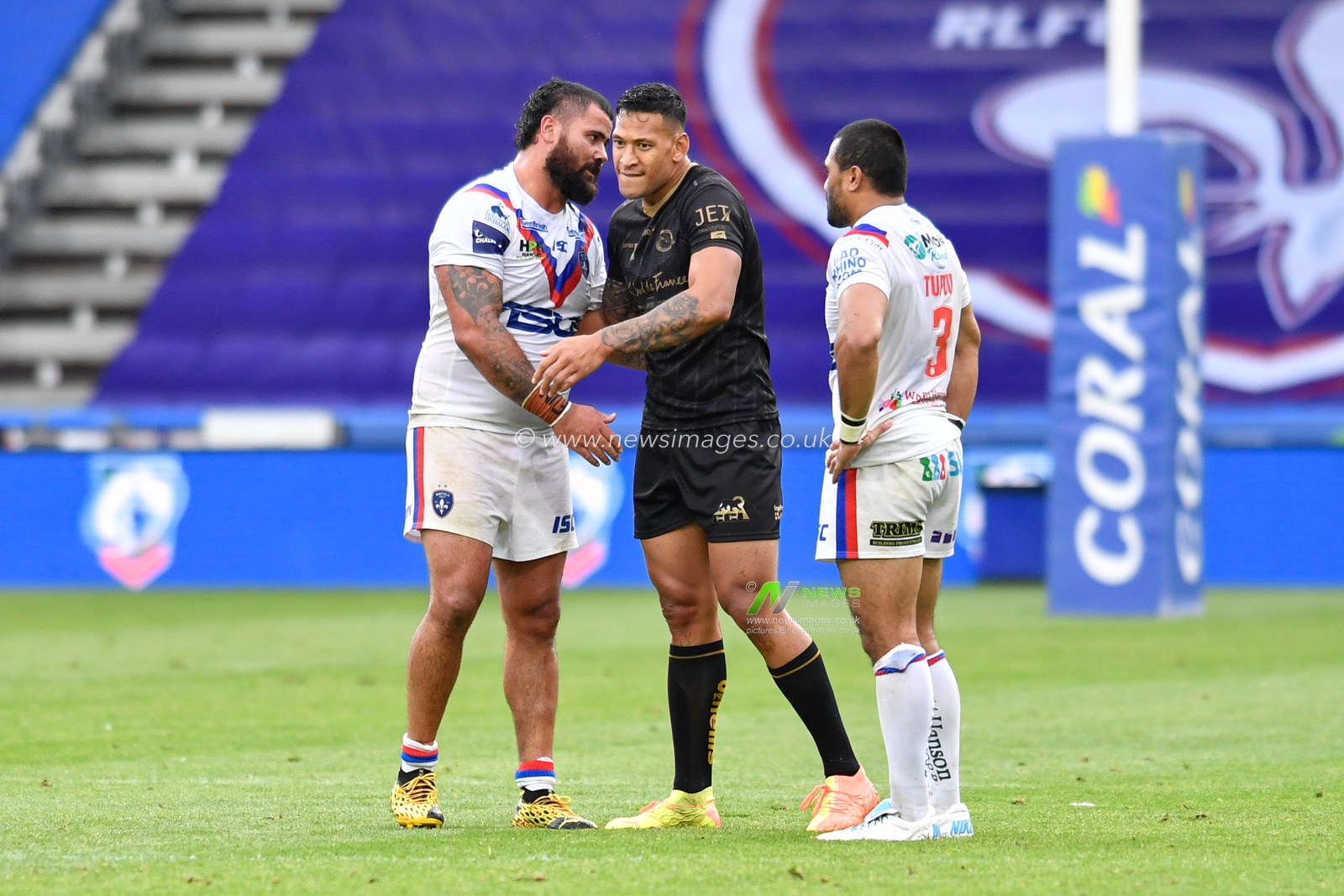 David Fifita (8) of Wakefield Trinity shares a conversation with Israel Folau (4) of Catalans Dragons after the final whistle