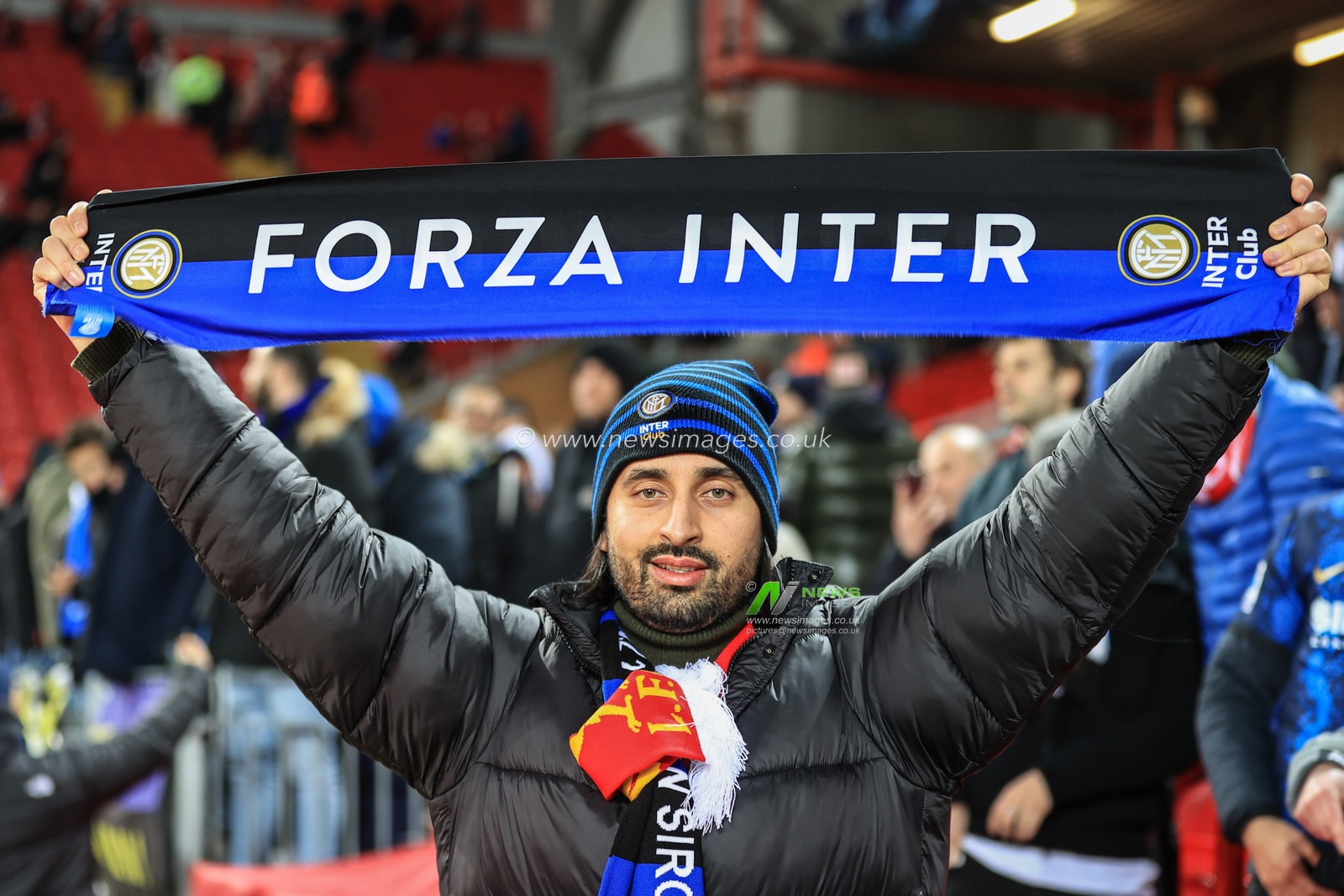An Inter Milan fan holding his scarf up