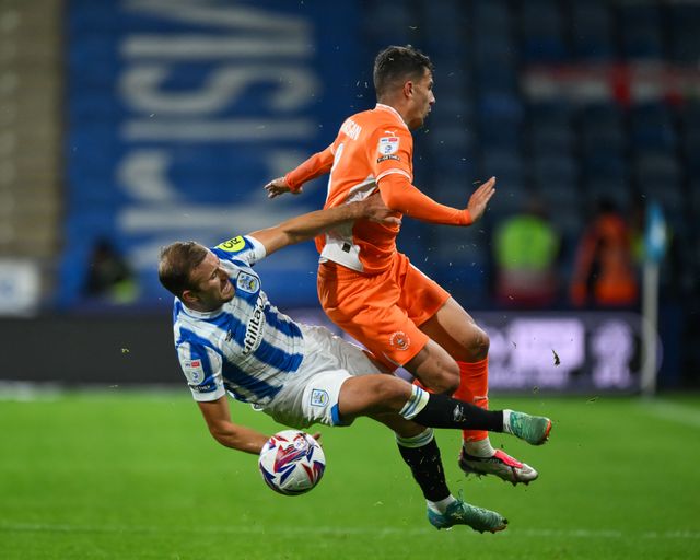 Albie Morgan of Blackpool is tackled by Herbie Kane of Huddersfield Town during the Sky Bet League 1 match Huddersfield Town vs Blackpool at John Smith's Stadium, Huddersfield, United Kingdom, 24th September 2024

(Photo by Craig Thomas/News Images)