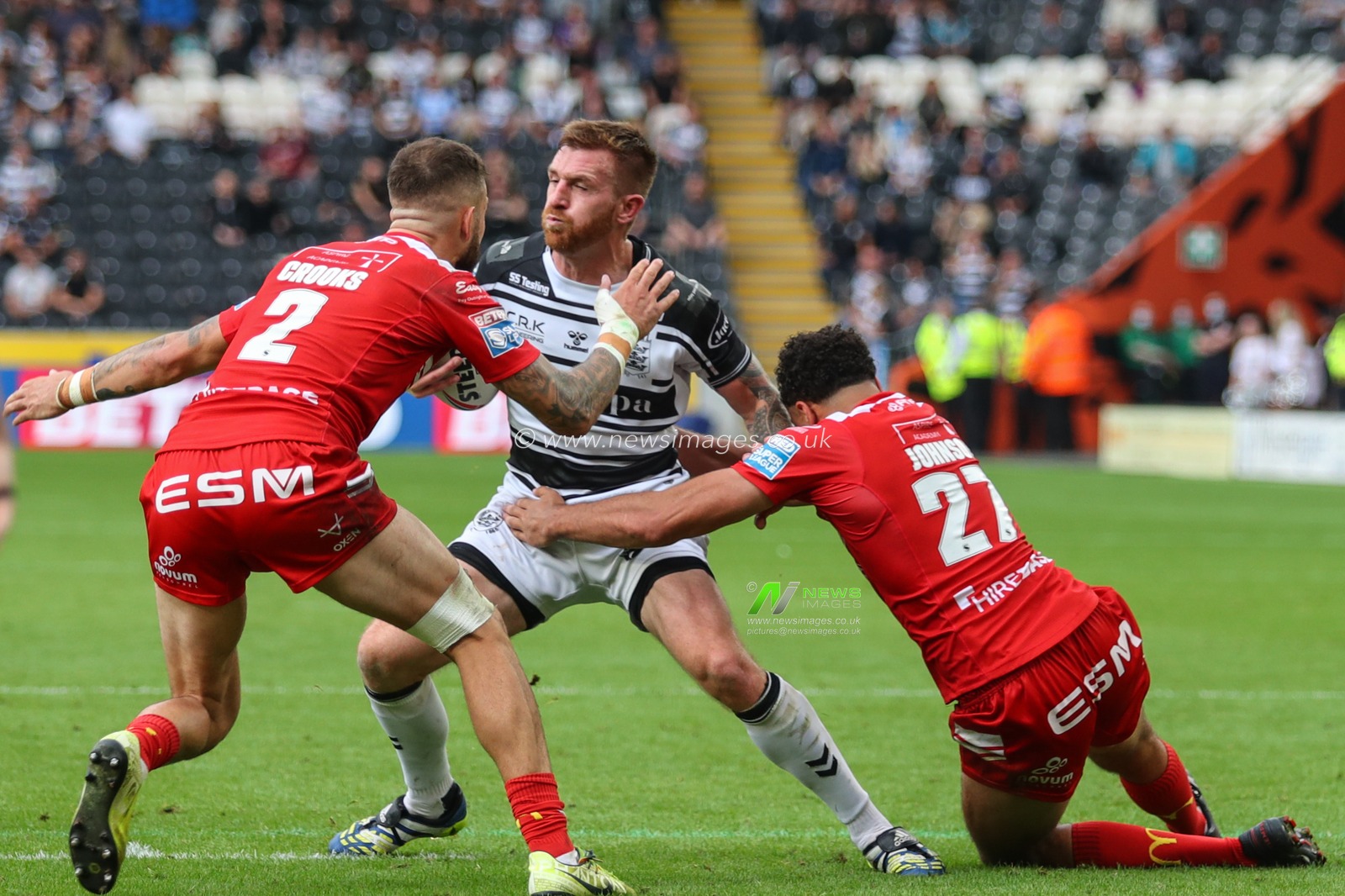 Marc Sneyd (7) of Hull FC is tackled by Luis Johnson (27) and Ben Crooks (2) of Hull KR