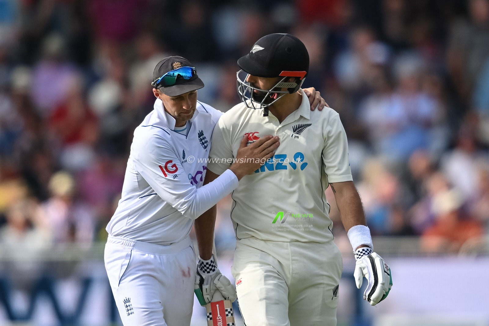 Joe Root of England gives Daryl Mitchell of New Zealand a pat on the back after heâ€™s caught on 190
