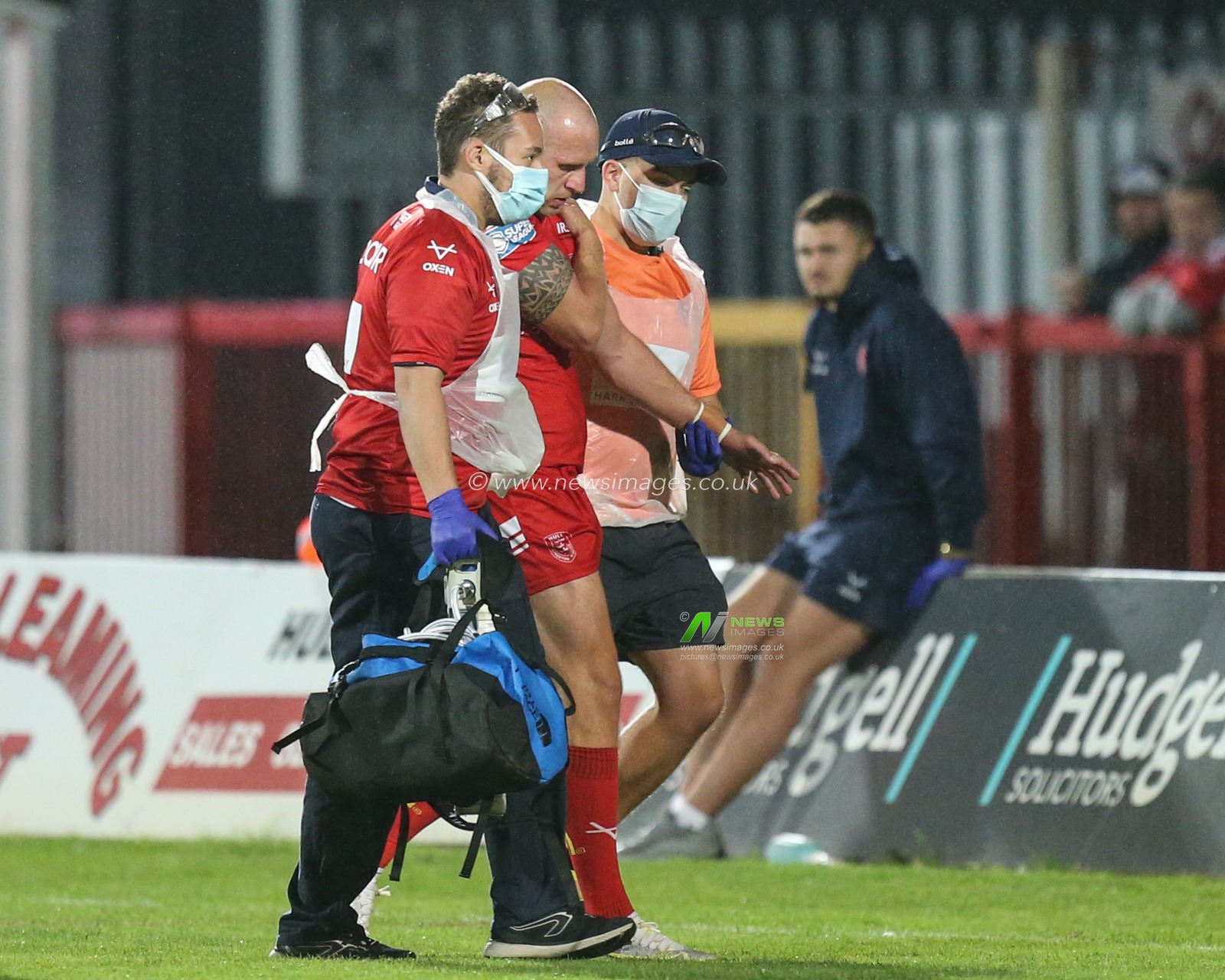 Dean Hadley (13) of Hull KR is helped off the pitch