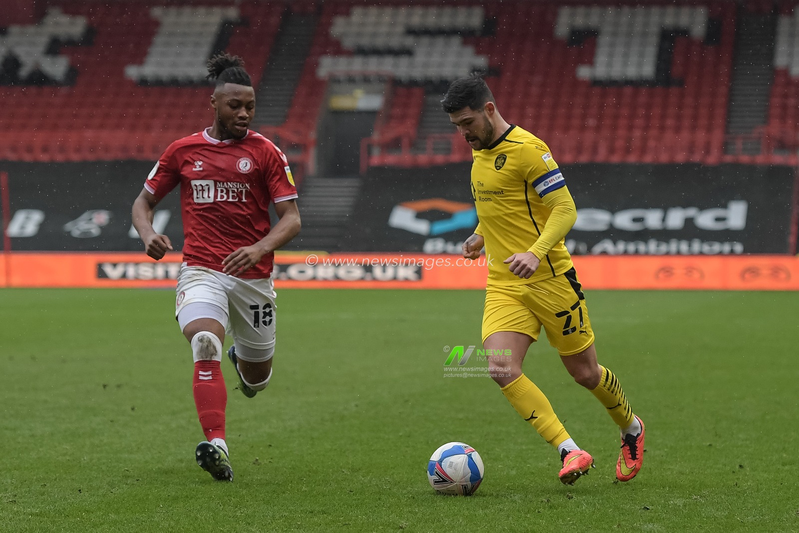 Alex Mowatt #27 of Barnsley crosses the ball under pressure from Antoine Semenyo #18 of Bristol City