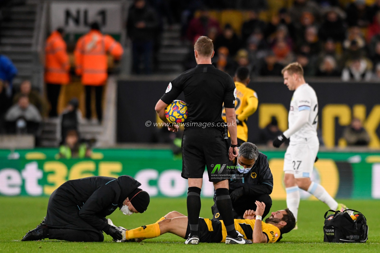Joao Moutinho #28 of Wolverhampton Wanderers receives treatment on the pitch after an injury
