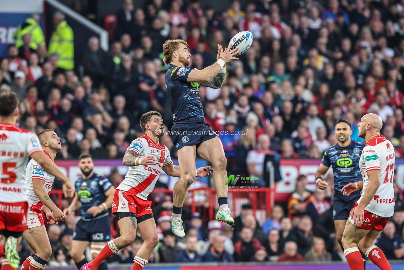Adam Keighran of Wigan Warriors knocks the ball back during the 2025 Betfred Super League Grand Final Hull KR v Wigan Warriors at Old Trafford, Manchester, United Kingdom, 11th October 2025

(Photo by Alfie Cosgrove/News Images)