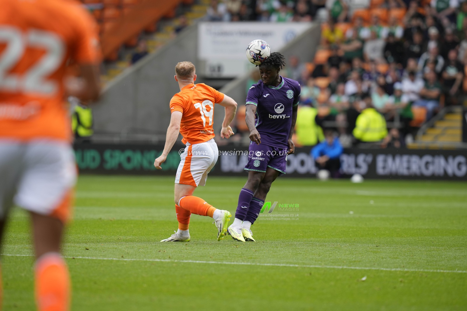 Kanayo Megwa #26 of Hibernian heads clear under pressure from Shayne Lavery #19 of Blackpool during the Pre-season friendly match Blackpool vs Hibernian at Bloomfield Road, Blackpool, United Kingdom, 29th July 2023

(Photo by Steve Flynn/News Images)