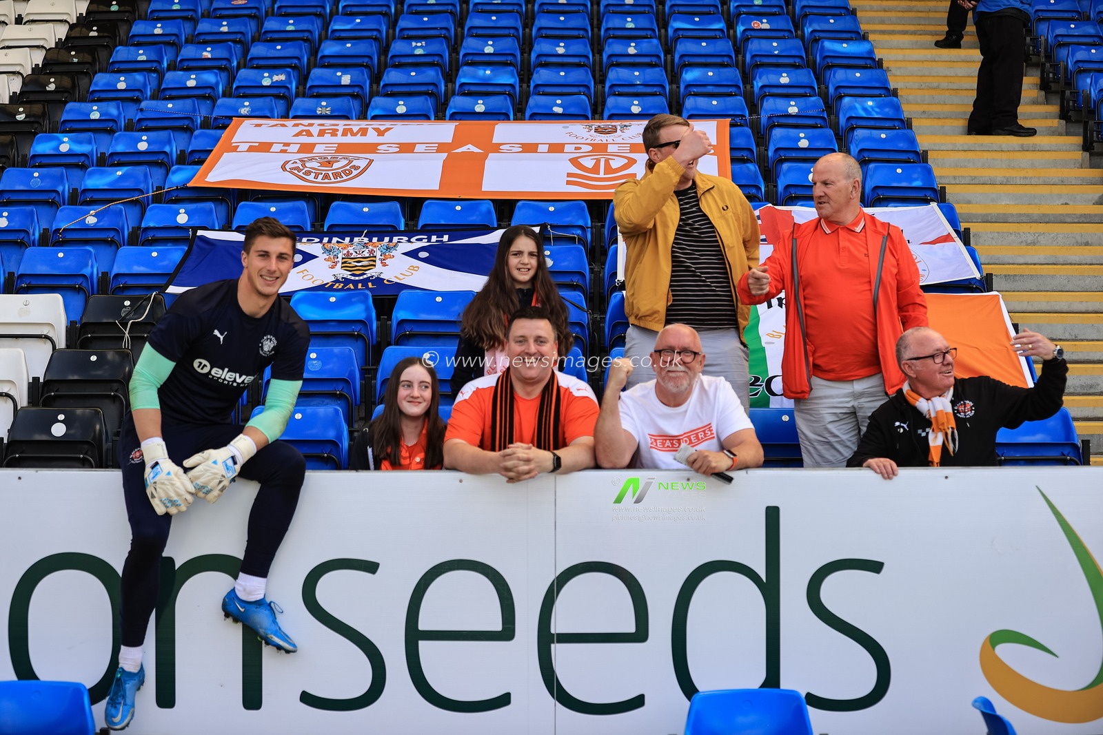 Stuart Moore #13 of Blackpool with the traveling Blackpool fans